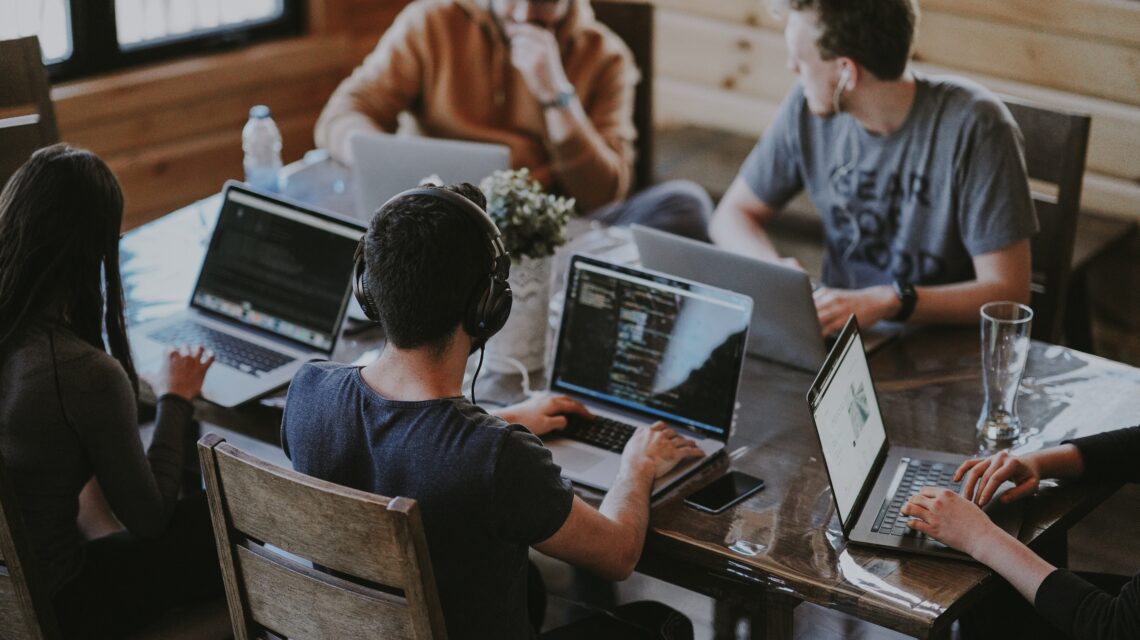 group of people using laptop computer