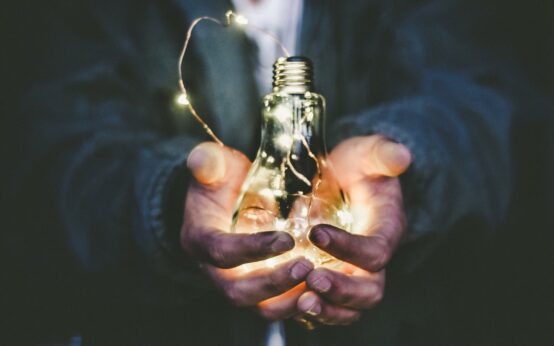 man holding incandescent bulb