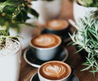 shallow focus photography of coffee late in mug on table