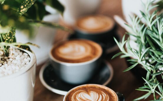 shallow focus photography of coffee late in mug on table