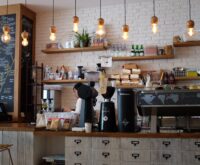 black kitchen appliance on kitchen island with pendant lights