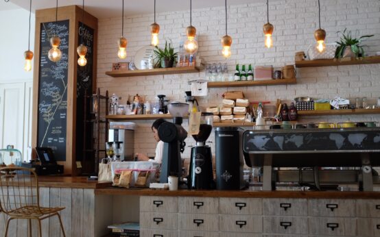 black kitchen appliance on kitchen island with pendant lights