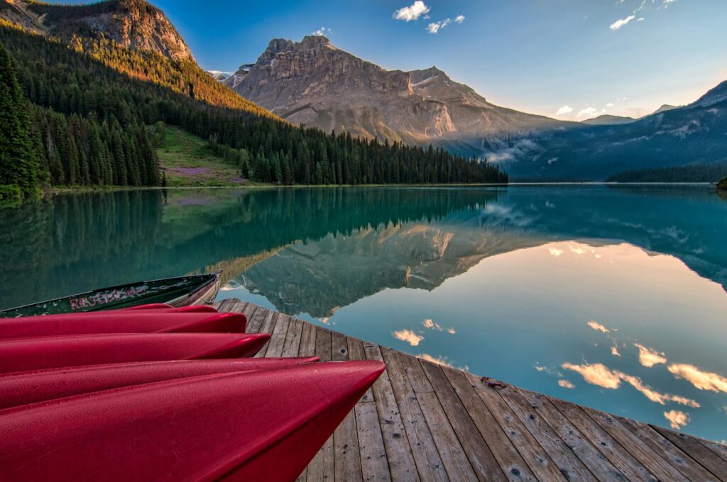Calm lake reflecting majestic mountains in a tranquil national park setting.