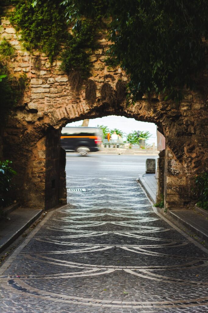 Ancient stone walls covered in moss and ivy create a serene atmosphere in one of Rome's quiet spots.