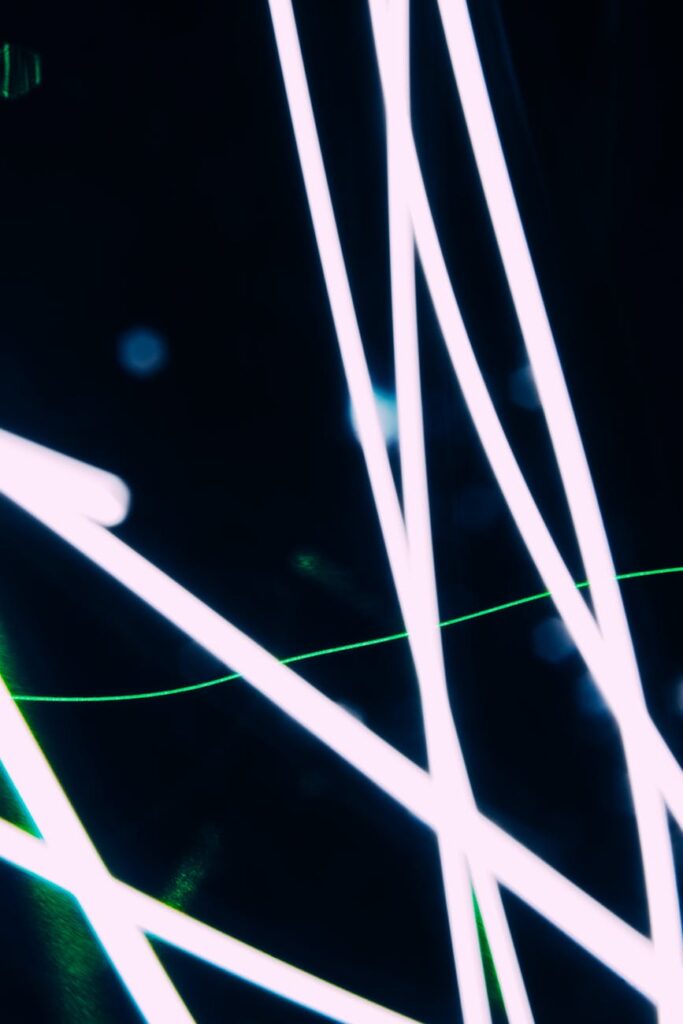 An abstract, artistic representation of an artificial intelligence neural network with bright blue and purple lights.
