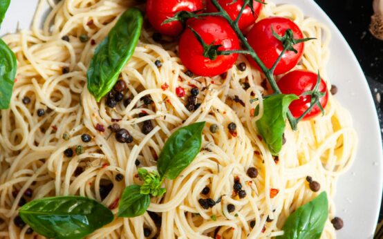 A vibrant, healthy meal featuring grilled salmon, a fresh spinach salad with walnuts, and a side of mixed berries, representing foods that reduce inflammation.