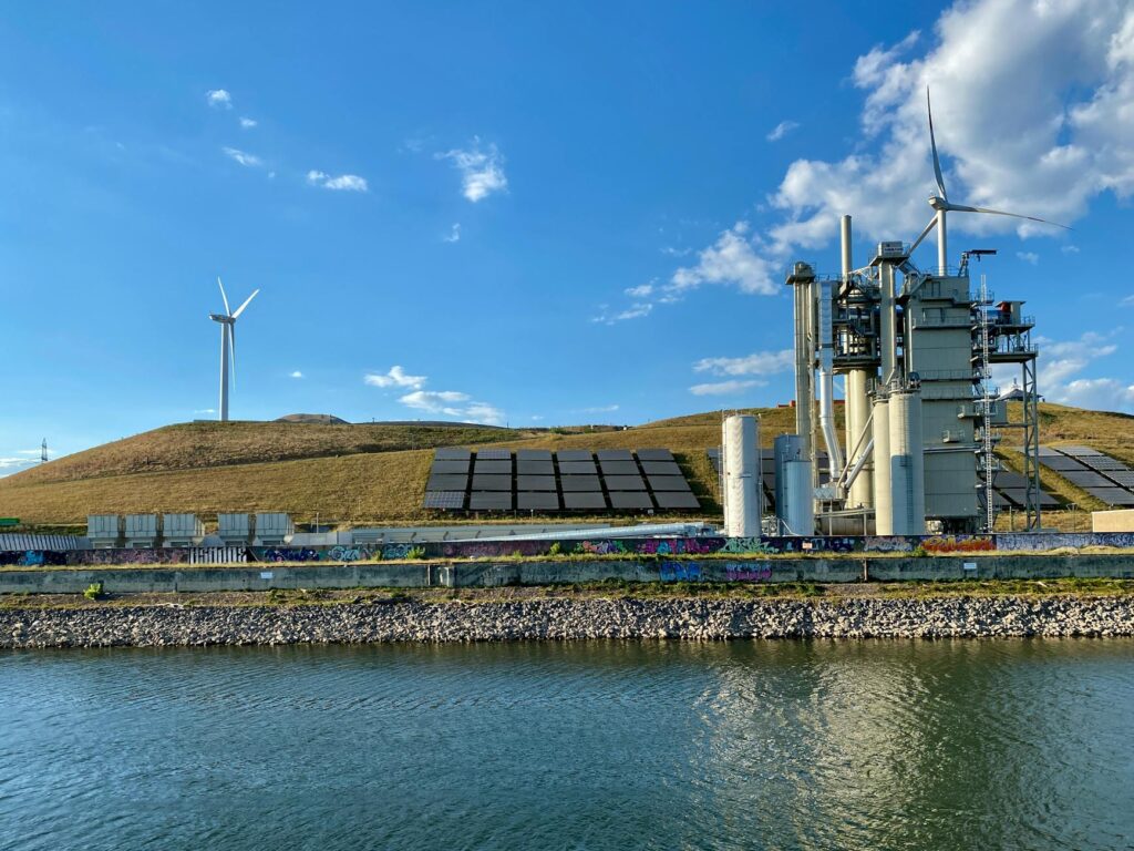 Solar panels providing clean energy to a water purification facility with a clear blue sky.