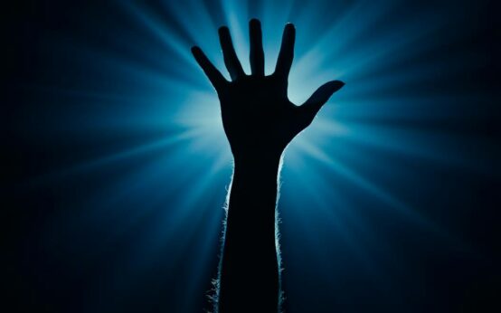 A person's finger touching a glowing, digital brain, symbolizing the connection between human and artificial intelligence.