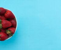 A top-down view of a delicious and colorful Buddha bowl filled with quinoa, chickpeas, avocado, and fresh greens, showcasing a healthy plant-based meal.