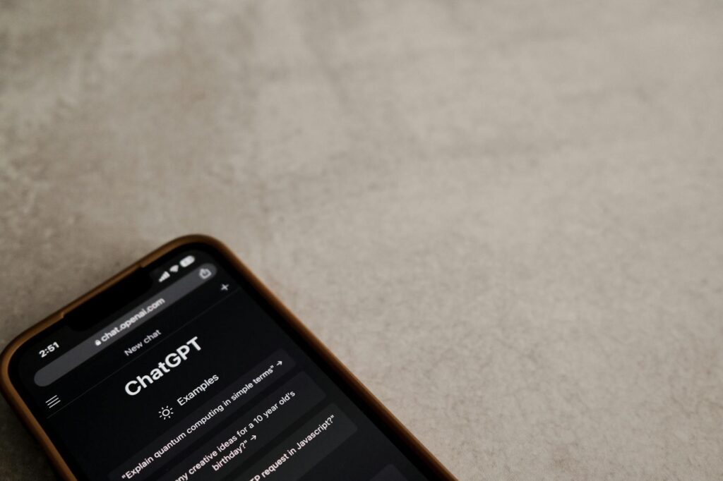 A smartphone displaying a guided meditation app, held in someone's hand with a blurred park background.