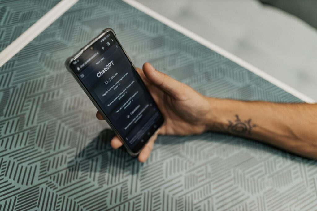 A person's hand touching a floating, holographic user interface with data charts and graphs.