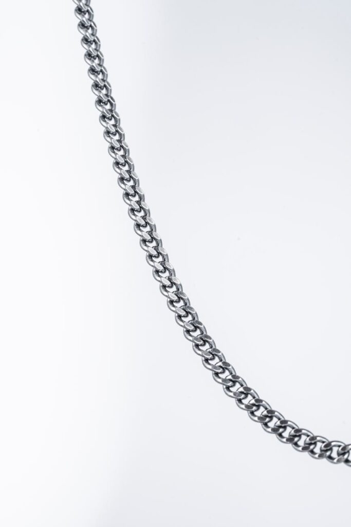 Close-up of digital, illuminated chain links, illustrating the concept of a blockchain.