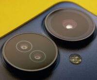A detailed close-up shot of a modern smartphone's multiple camera lenses.
