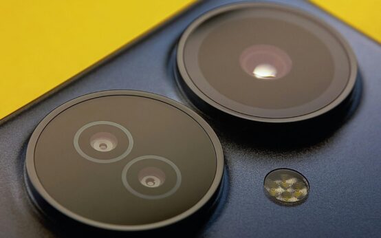 A detailed close-up shot of a modern smartphone's multiple camera lenses.