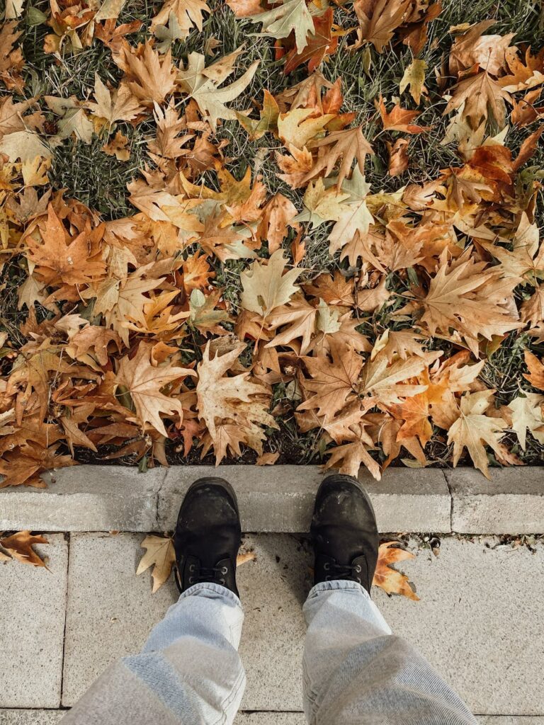 A first-person perspective of someone's shoes walking on a historic cobblestone street in a new city.