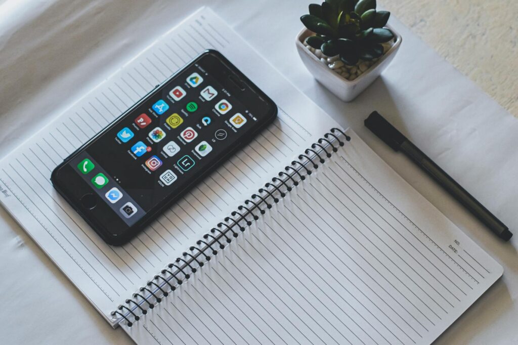 A flatlay desk scene with a smartphone open to Instagram, surrounded by coffee and dollar bills, symbolizing making money online.