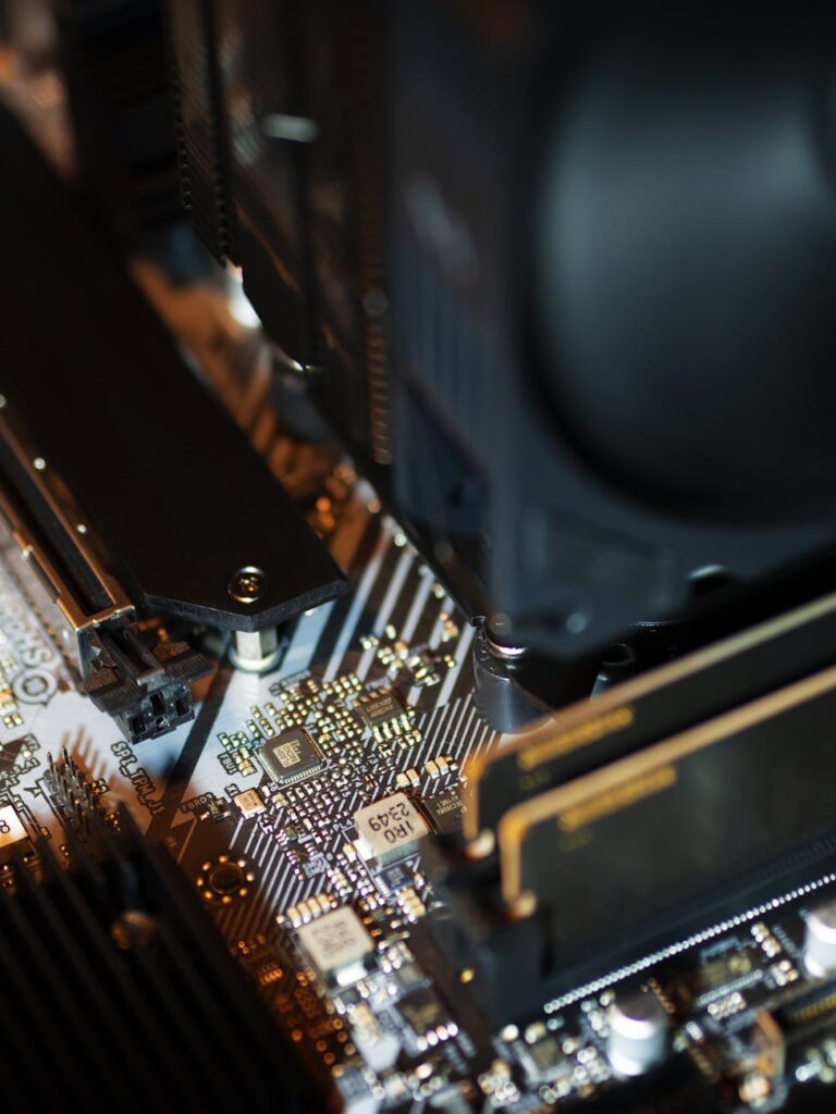 A detailed macro shot of a complex computer circuit board with many components and pathways.