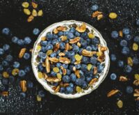 A vibrant assortment of immunity-boosting citrus fruits like oranges and grapefruits in a white bowl.