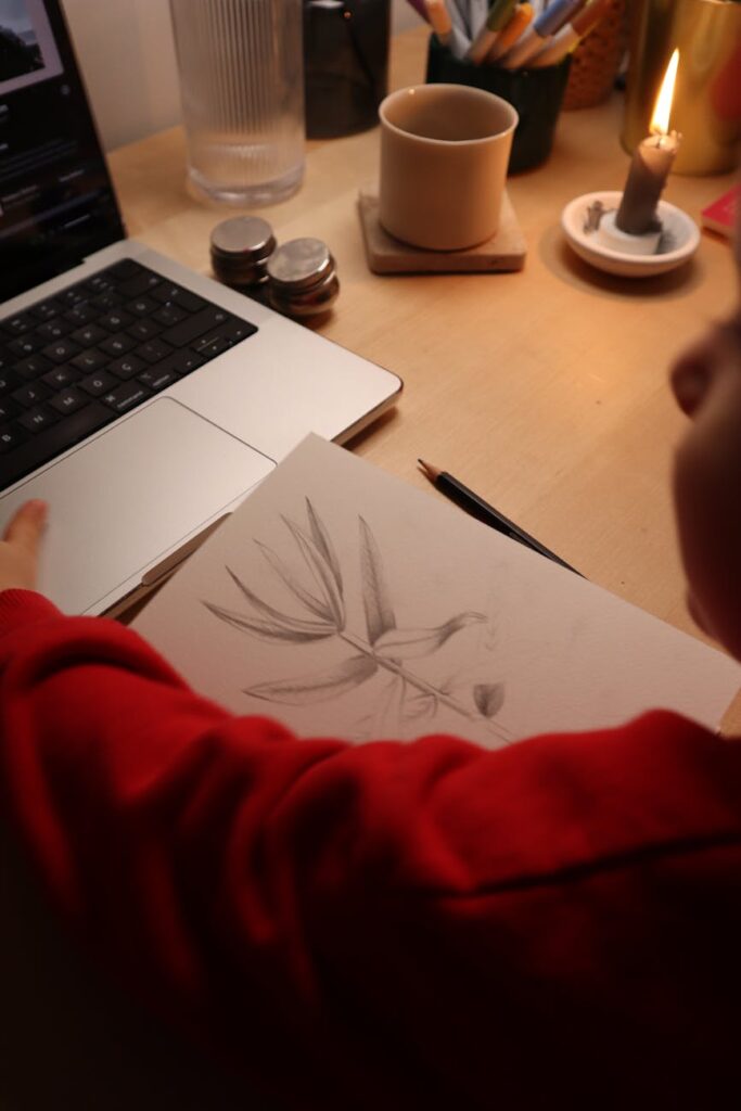 A minimalist desk setup showing the creative process of designing a WordPress theme on a laptop.