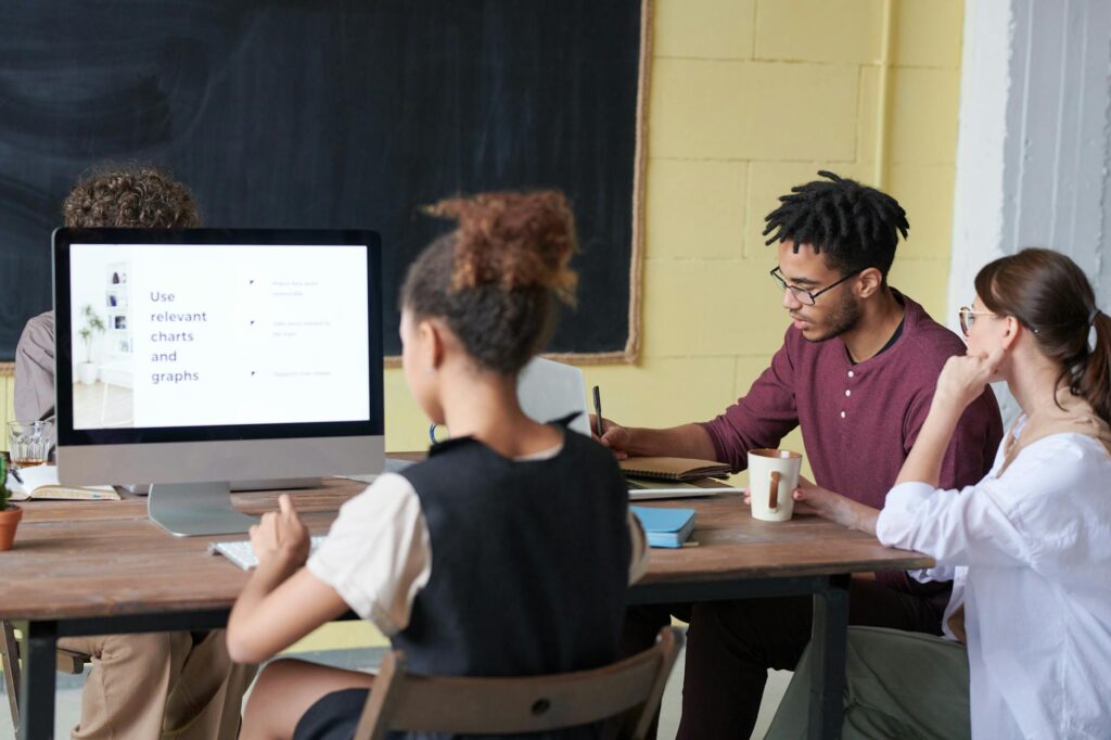 A successful freelance developer analyzing financial growth charts on a modern computer setup.