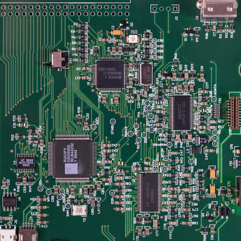 A close-up of a circuit board designed in the shape of a human brain with light pulsing through its pathways.