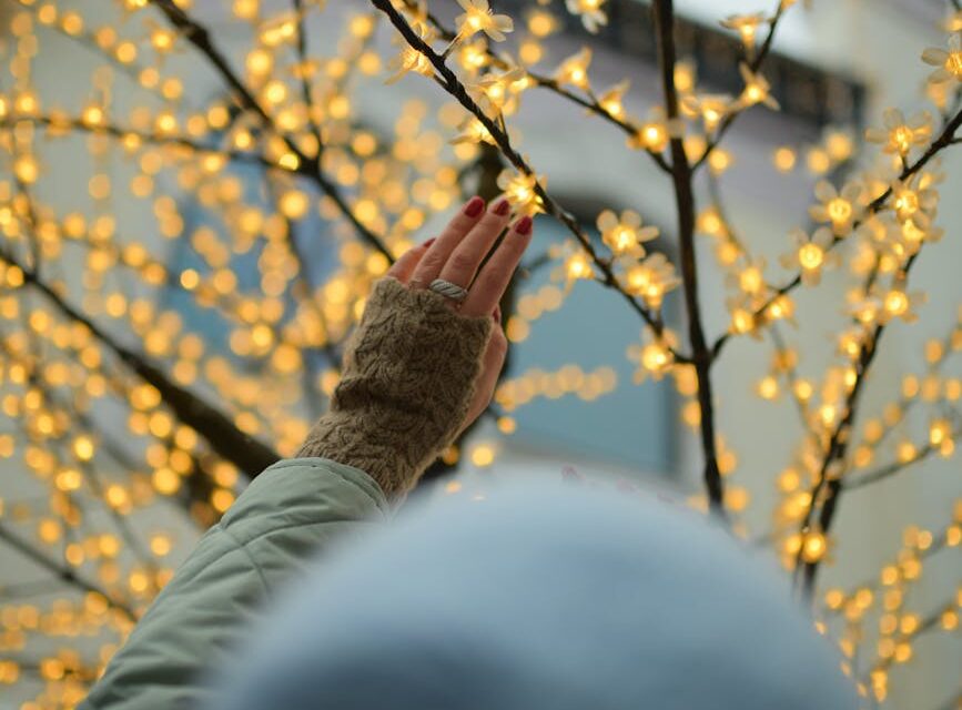 A person's finger touching a glowing blue digital brain, symbolizing the human-AI connection.
