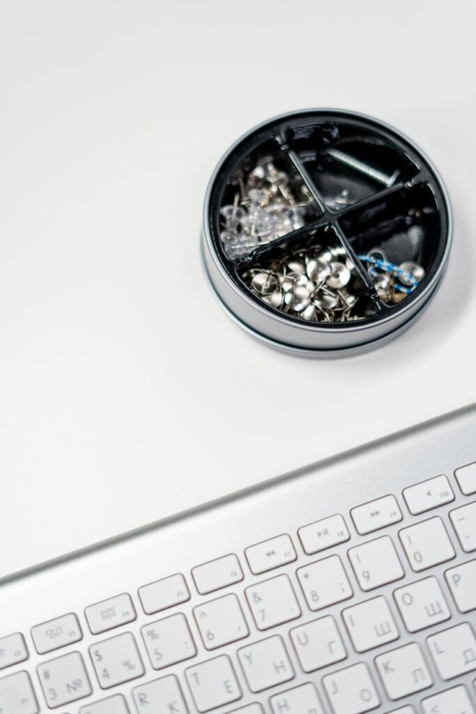 A top-down view of a desk with a laptop, notebook, coffee, and money, representing online income.