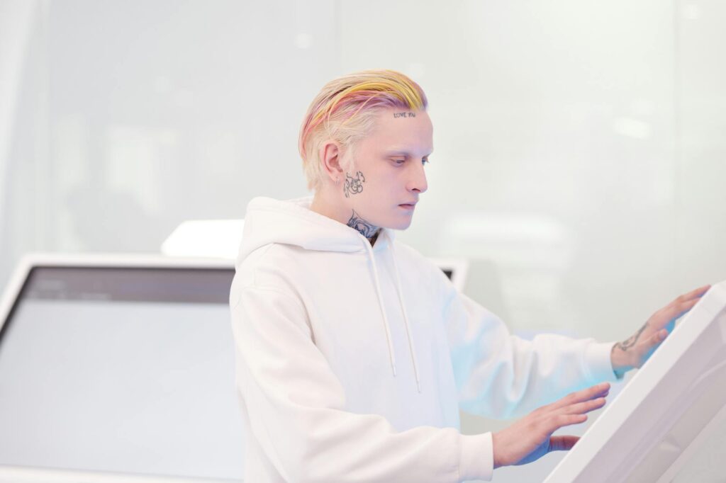 Close-up of a person's hand interacting with a holographic display showing complex data and AI analytics.