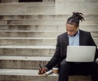 A small business owner analyzing charts and graphs on a laptop, representing AI-driven business intelligence.