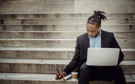 A small business owner analyzing charts and graphs on a laptop, representing AI-driven business intelligence.