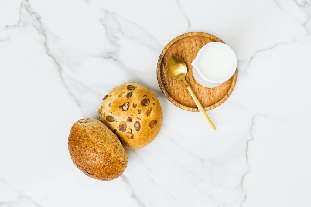 An overhead shot of various nuts and seeds, including almonds, walnuts, chia seeds, and pumpkin seeds, arranged in separate wooden bowls.