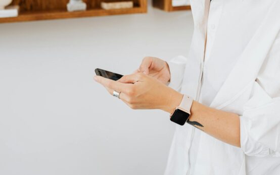 A person casually browsing an app on their smartphone that shows a dollar sign, symbolizing earning money online.