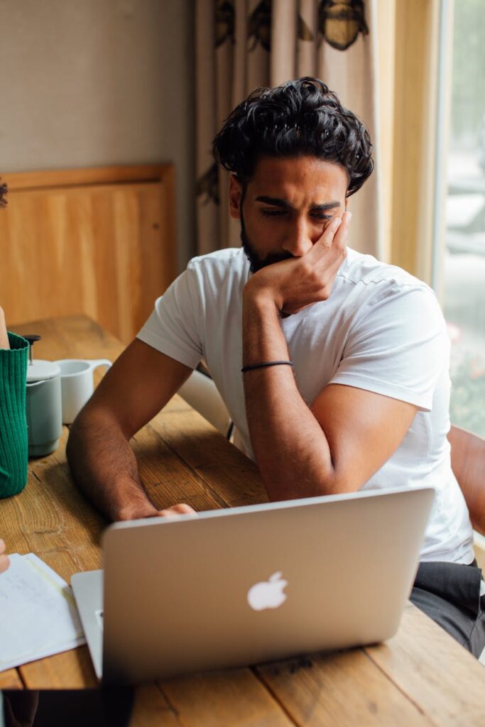 A happy woman in her home office earns extra income by testing websites and apps on her computer.