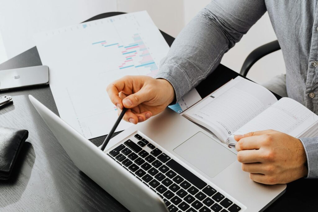 Close-up of a blogger analyzing website traffic and earnings data on a laptop screen.