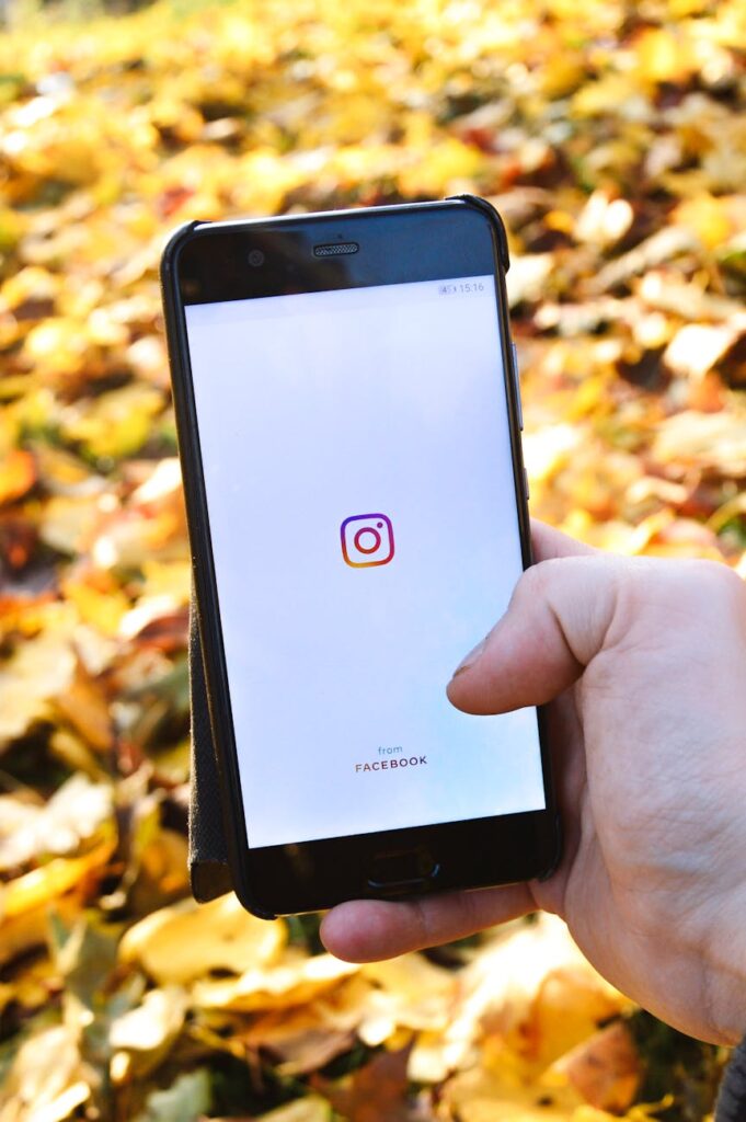 A close-up of a smartphone screen showing the Instagram Reels interface with coins and bills scattered around it.