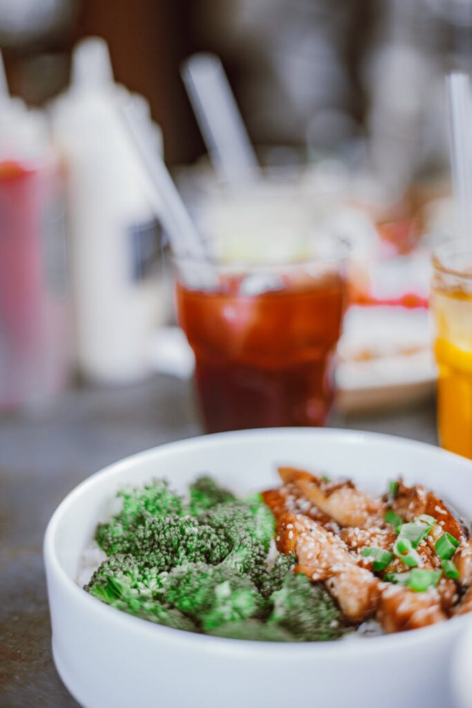 A healthy pre-workout meal of grilled chicken, brown rice, and broccoli on a plate.