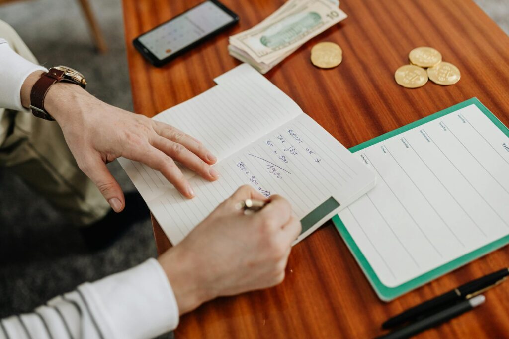 A travel photographer's desk with a camera, a passport, and several dollar bills, symbolizing earning money from photography.
