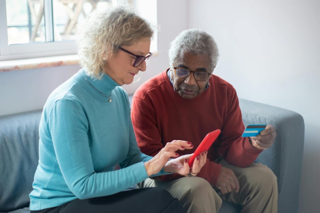 A happy customer making a purchase online with her credit card.