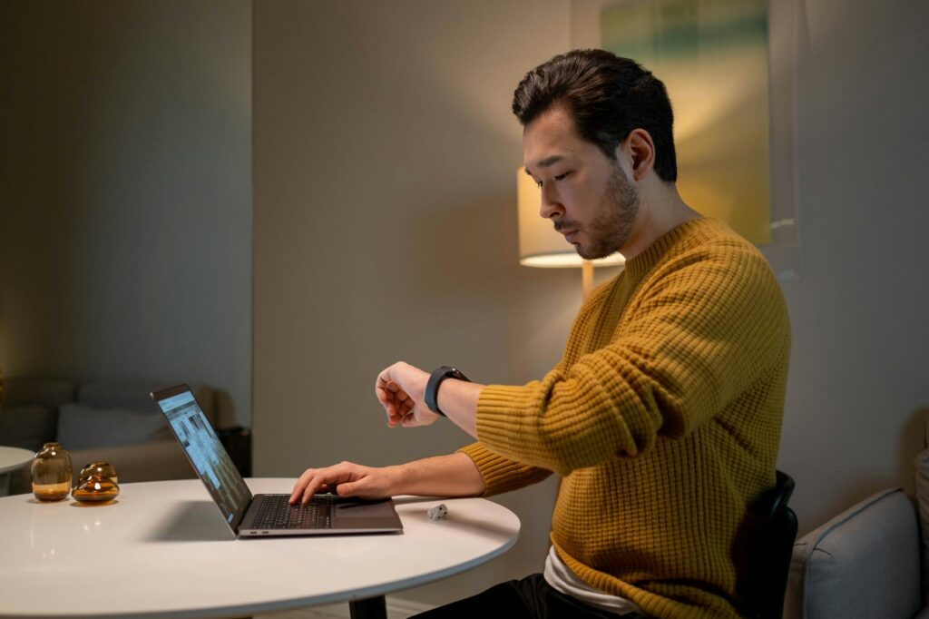 A focused scientist analyzing a complex 3D protein structure on a high-resolution computer monitor in a lab.