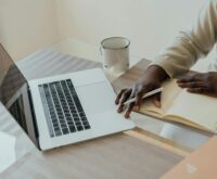 A freelancer typing on their laptop in a comfortable home office setting, focused on earning money online.