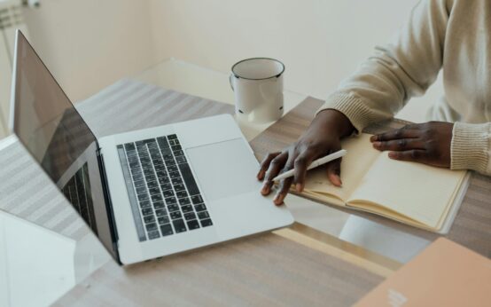 A freelancer typing on their laptop in a comfortable home office setting, focused on earning money online.