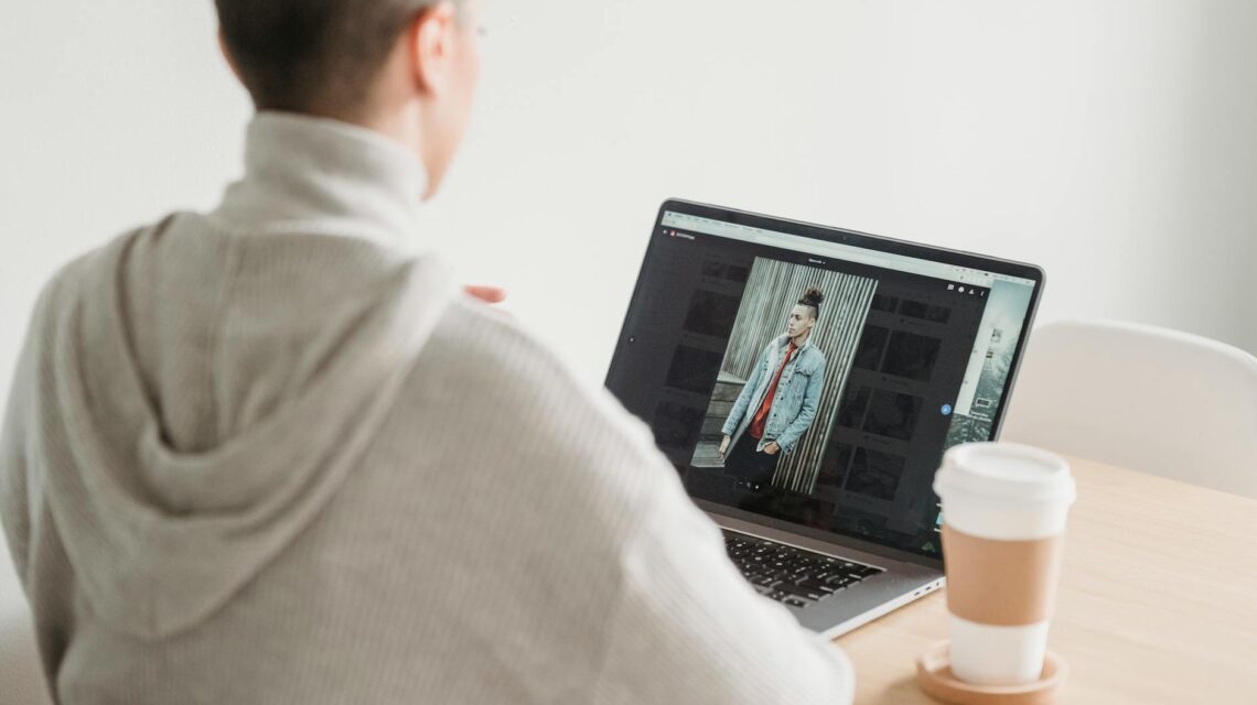 A person relaxing on a comfortable couch, earning money online with a laptop and a cup of coffee nearby.