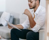 A small business owner analyzing AI-powered sales charts on their laptop.