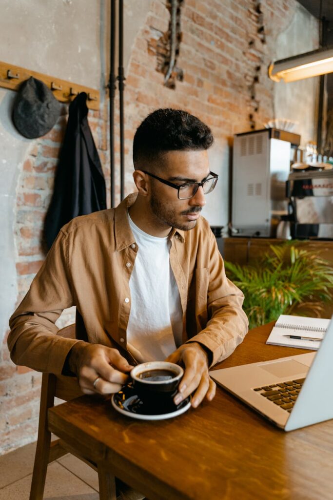 A person focused on their laptop displaying cryptocurrency charts, representing crypto management.