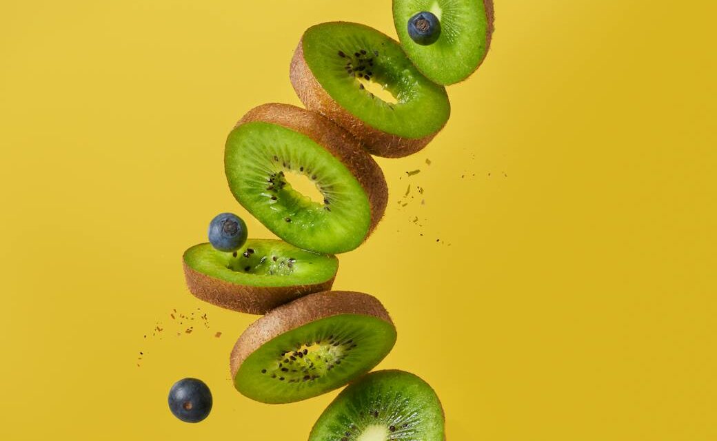 A colorful overhead shot of various immune-boosting superfoods, including oranges, lemons, garlic bulbs, and fresh spinach.