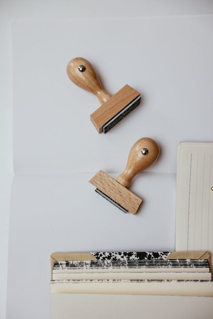 A blogger's desk setup with a laptop displaying a new blog post and a notepad with monetization goals.