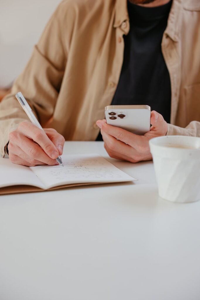 Close-up of a hand holding a smartphone with a successful payment notification on the screen.
