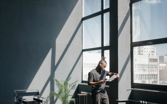 A person focused on their laptop while earning money online from a comfortable cafe.