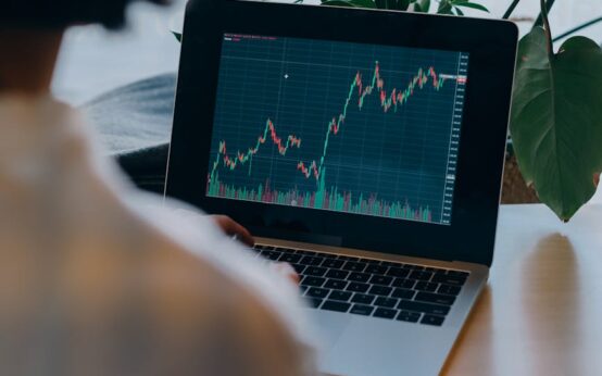 A small business owner analyzing charts and graphs on a laptop, representing AI-driven business intelligence.