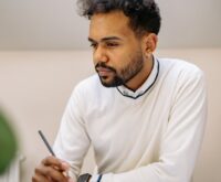 A focused entrepreneur analyzing financial growth charts on a laptop screen.